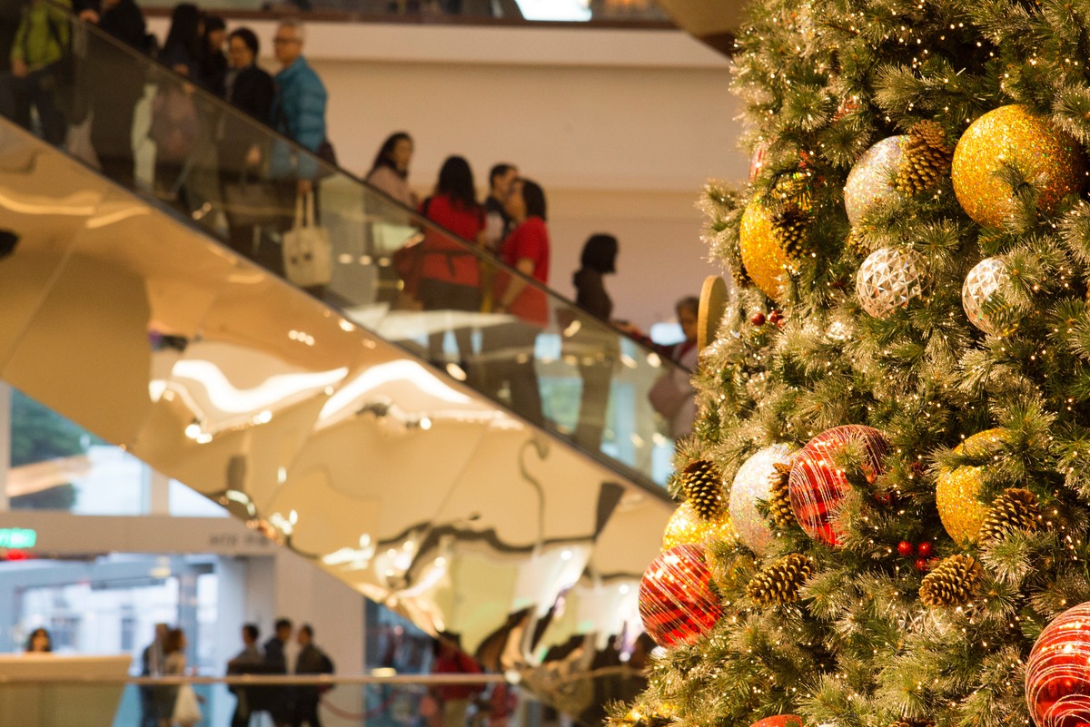 Shoppers riding a mall escalator during Black Friday shopping