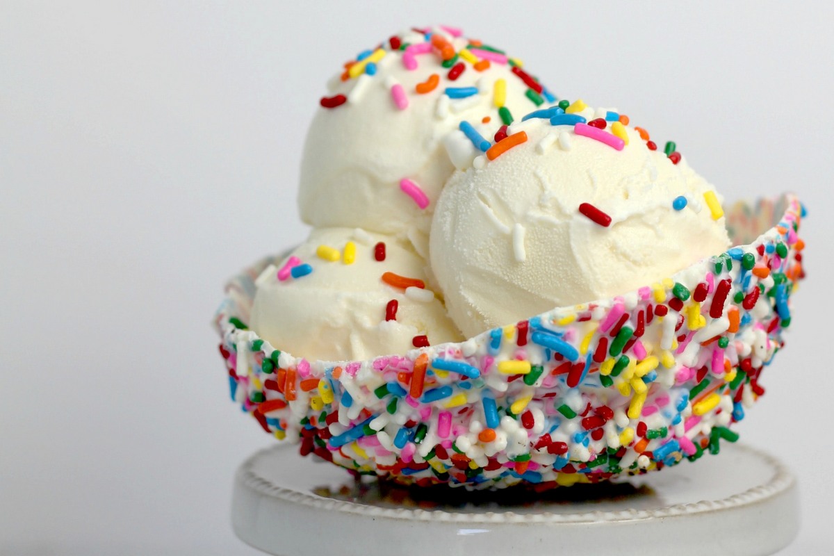 ice cream sprinkle bowl with three scoops of vanilla ice cream served by an ice cream shop business